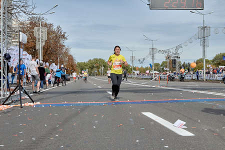 September 15, 2019 Minsk Belarus A tired woman crosses the finish line of a marathonのeditorial素材