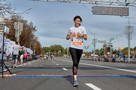 September 15, 2019 Minsk Belarus A marathon race in which a woman crosses the finish line on a city roadのeditorial素材