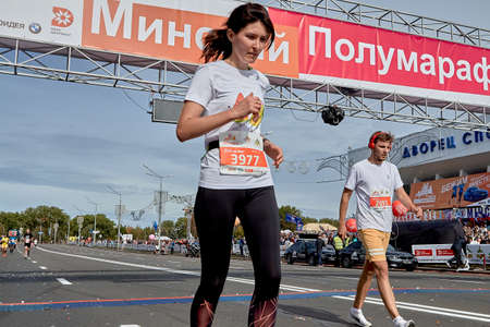 September 15, 2019 Minsk Belarus A marathon race in which a man and a woman cross the finish line on a city roadのeditorial素材