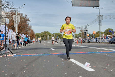 September 15, 2019 Minsk Belarus A tired woman crossed the finish line of the marathonのeditorial素材
