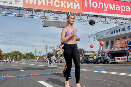 September 15, 2019 Minsk Belarus A tired woman crosses the finish line of a marathonのeditorial素材