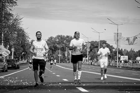 September 15, 2019 Minsk Belarus In black and white, participants run a marathon distance along a city roadのeditorial素材