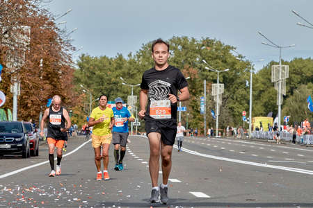 September 15, 2019 Minsk Belarus The participant runs on the city road of the marathon ahead of all the athletesのeditorial素材