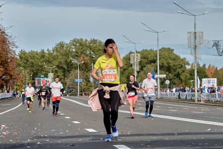 September 15, 2019 Minsk Belarus A woman runs along the city road of the Minsk half marathonのeditorial素材