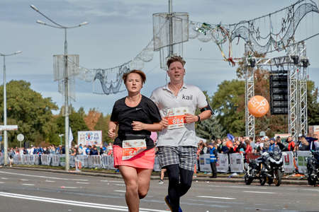 September 15, 2019 Minsk Belarus A marathon race in which a man and a woman run along a city roadのeditorial素材