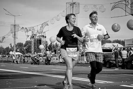 September 15, 2019 Minsk Belarus A marathon race in which a happy married couple crosses the finish line on a city roadのeditorial素材