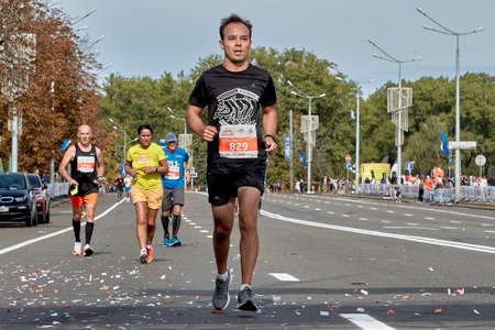 September 15, 2019 Minsk Belarus Close-up of a participant running on a city road marathon ahead of all athletesのeditorial素材