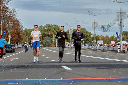 September 15, 2019 Minsk Belarus A marathon race in which three young participants run to the finish line on a city roadのeditorial素材