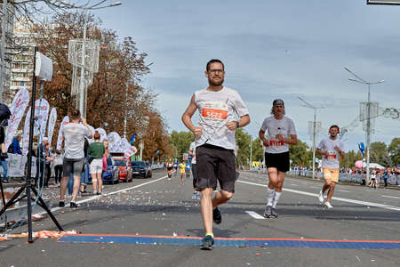 September 15, 2019 Minsk Belarus Participants cross the finish line of the marathon on a city roadのeditorial素材
