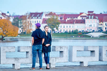 October 19, 2019 Minsk Belarus A guy and a girl on a date are standing on the riverbankのeditorial素材