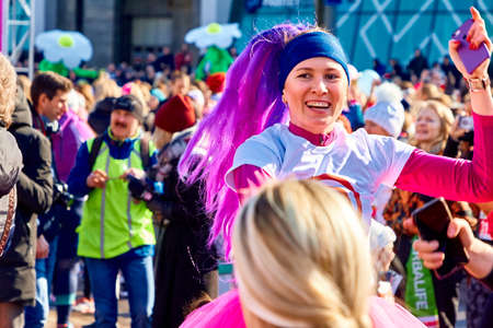 March 8, 2019 Minsk Belarus Women's Day Race on March 8 Emotional happy girl with purple hair dancing in the streetのeditorial素材