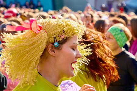 March 8, 2019 Minsk Belarus Women's Day Race on March 8. A young woman with yellow hair and clothes is standing on the street performingのeditorial素材