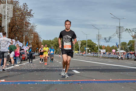 September 15, 2019 Minsk Belarus The participant runs to the finish of the marathon ahead of all athletesのeditorial素材
