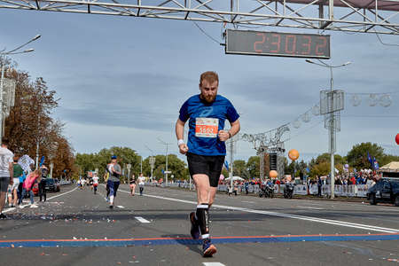 September 15, 2019 Minsk Belarus A dedicated athlete crosses the finish line of a marathonのeditorial素材