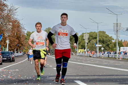 September 15, 2019 Minsk Belarus Two participants run on the city road of the half marathon in Minskのeditorial素材