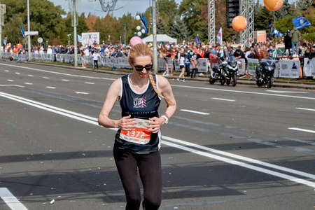 September 15, 2019 Minsk Belarus A marathon race in which a close-up of an active woman runs to the finish lineのeditorial素材