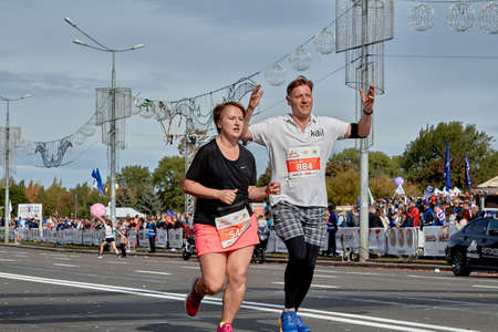 September 15, 2019 Minsk Belarus A marathon race in which a happy married couple runs along a city roadのeditorial素材