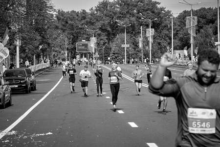 September 15, 2019 Minsk Belarus Happy participants run along the city road of the half marathon in Minskのeditorial素材