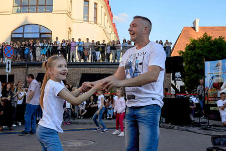 June 1, 2019 Minsk Belarus Happy father and daughter stand in the evening against the blue sky on the streetのeditorial素材