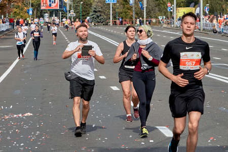 September 15, 2019 Minsk Belarus A marathon race in which athletes with their smartphones run to the finish line on a city roadのeditorial素材