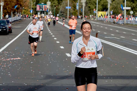 September 15, 2019 Minsk Belarus A happy woman runs along the city road of the half marathon in Minskのeditorial素材