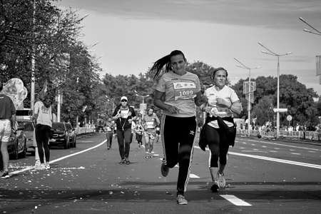 September 15, 2019 Minsk Belarus In black and white a marathon race in which two active competitors run on a city roadのeditorial素材