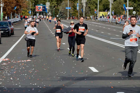 September 15, 2019 Minsk Belarus A marathon race in which participants with smartphones in their hands run to the finish lineのeditorial素材