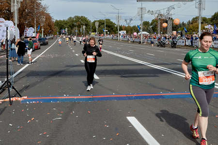 September 15, 2019 Minsk Belarus Two women cross the finish line on the city route of the half marathon in Minskのeditorial素材