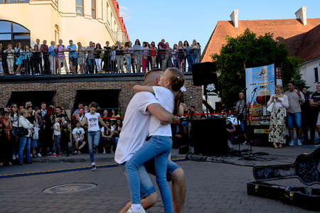 June 1, 2019 Minsk Belarus A street concert where a happy father and a little girl dance in front of a crowd of peopleのeditorial素材