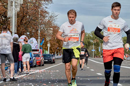 September 15, 2019 Minsk Belarus Close up of two athletes running on the city route of the half marathon in Minskのeditorial素材