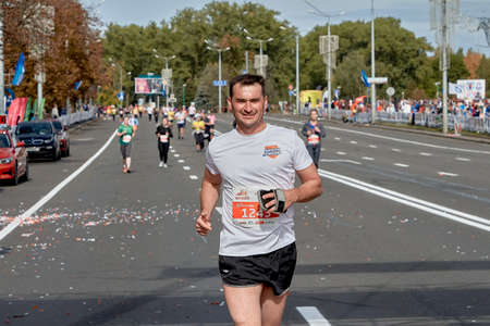 September 15, 2019 Minsk Belarus An active happy participant runs a marathon on a city roadのeditorial素材