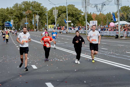 September 15, 2019 Minsk Belarus Happy participants run along the city road of the half marathon in Minskのeditorial素材