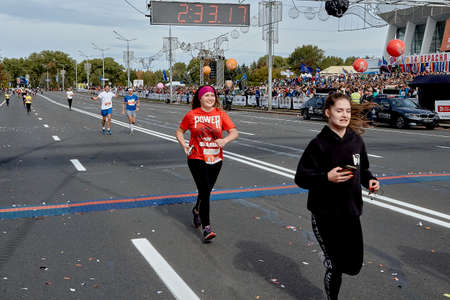 September 15, 2019 Minsk Belarus A marathon race in which two women cross the finish line on a city roadのeditorial素材
