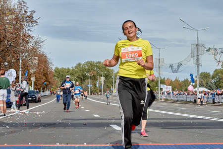 September 15, 2019 Minsk Belarus A marathon race in which an active woman crosses the finish line with her eyes closedのeditorial素材
