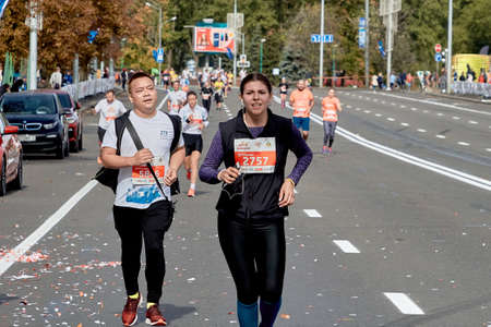 September 15, 2019 Minsk Belarus A marathon race in which a man and a woman run to the finish line on a city roadのeditorial素材