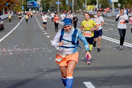 September 15, 2019 Minsk Belarus Close-up of an active, happy woman running a marathon on a city roadのeditorial素材