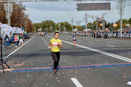 September 15, 2019 Minsk Belarus Minsk hosts a half-marathon in which a beautiful woman crosses the finish lineのeditorial素材