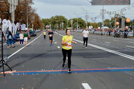 September 15, 2019 Minsk Belarus A happy woman crosses the finish line along a city roadのeditorial素材