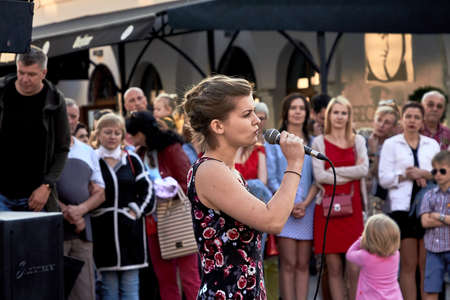 May 25, 2019 Minsk Belarus A theatrical performance in which a young woman with a microphone sings in the streetのeditorial素材