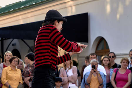 May 25, 2019 Minsk Belarus Close-up, girl actress shows theatrical performance with a red ball at the street.のeditorial素材
