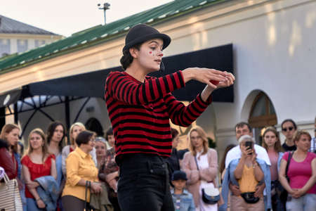 May 25, 2019 Minsk Belarus Girl actress in mime costume and makeup shows theatrical performance with a red ballのeditorial素材