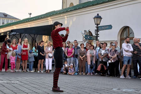 May 25, 2019 Minsk Belarus Close-up, girl actress shows theatrical performance with a red ball at the street.のeditorial素材