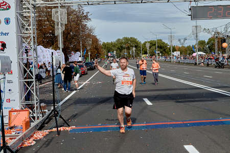 September 15, 2019 Minsk Belarus A marathon race in which an active participant crosses the finish line with their hand raisedのeditorial素材