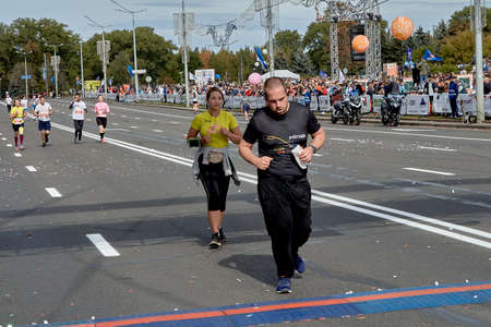 September 15, 2019 Minsk Belarus Marathon participants run to the finish line on a city roadのeditorial素材