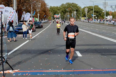 September 15, 2019 Minsk Belarus An athlete runs to the finish line of the marathon on a city roadのeditorial素材