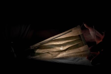 Medical mask in the dark, the concept of viral infectionの写真素材