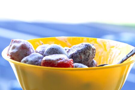 Fresh strawberries in sour cream on a blurred background. Vitamin breakfastの写真素材