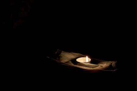 A candle is lit in memory of the victims.の写真素材