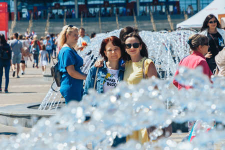 June 23, 2019 Minsk Belarus Best friends are standing at the fountain on the summer city street.のeditorial素材