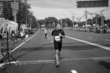 September 15, 2019 Minsk Belarus In the black-and-white image, a participant crosses the finish line of the Minsk half marathonのeditorial素材